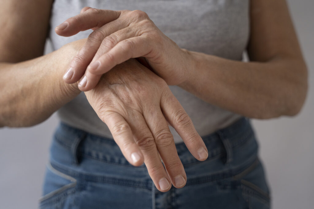 Close-up of a middle-aged woman holding her wrist due to hand and wrist pain